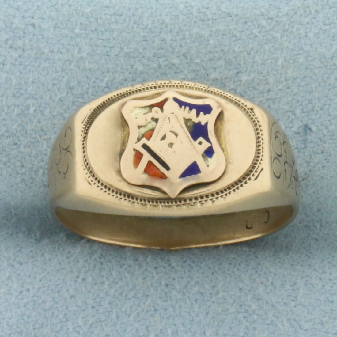 Antique Masonic Ring in 10k Yellow Gold: In 10k Yellow Gold. 11mm wide at center. Scroll details on sides. Worn enamel details. Size 7.5. 5.8g.