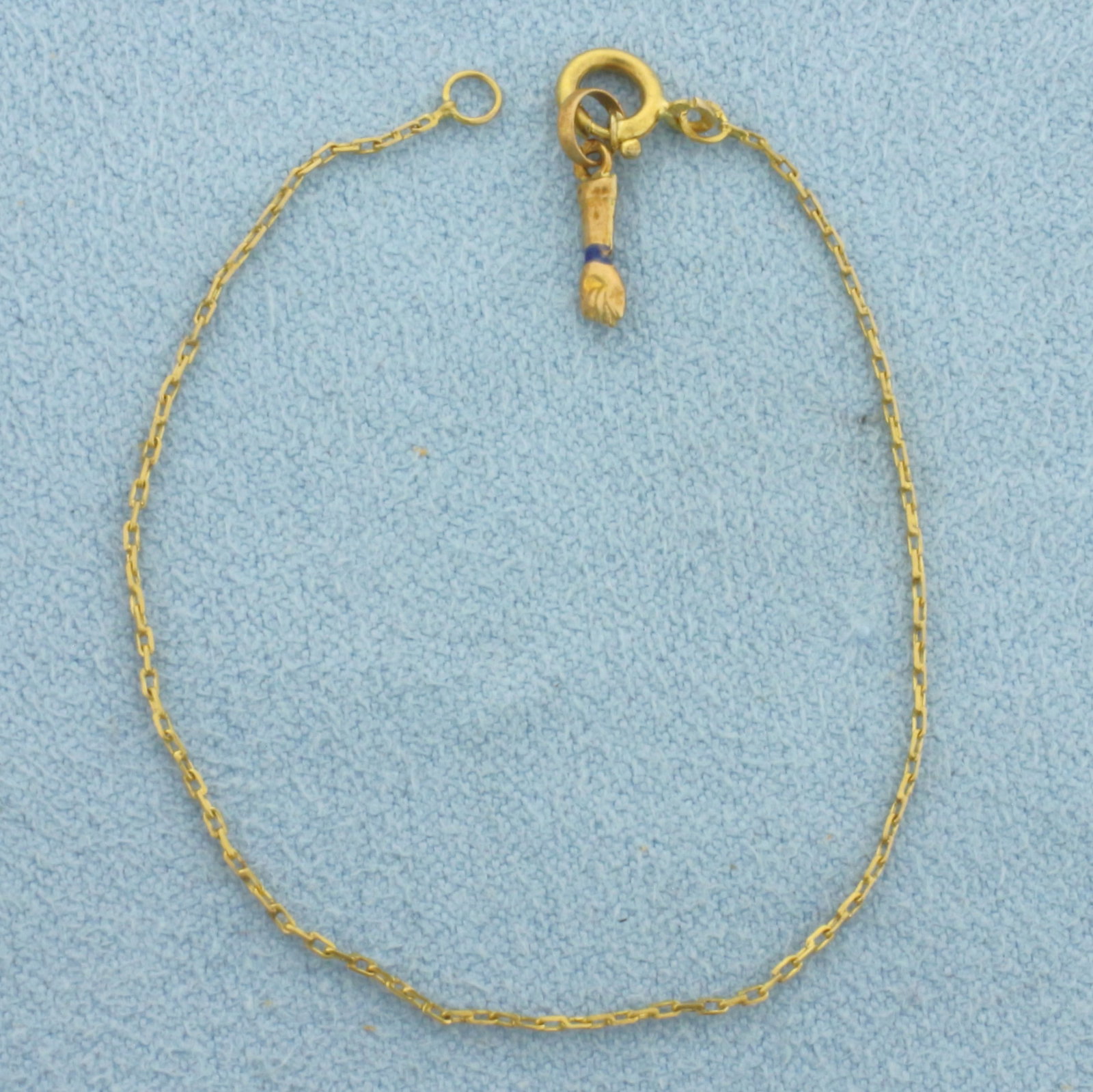 Figa Hand Protection Bracelet For Baby or Child in 20k Yellow Gold: In 20k Yellow Gold. 5 inches long. 0.6mm wide. Figa Hand charm, protective amulet. Spring clasp. .5g.