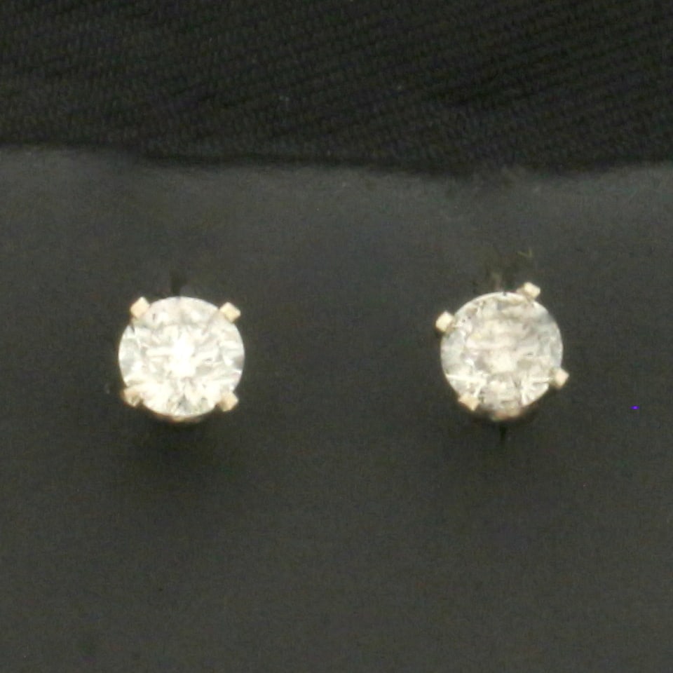 Diamond Stud Earrings in 14k White Gold: In 14k White Gold. Contains two high quality round brilliant diamonds, 1/3ct TW, I color/I clarity, eye clean, great cut for added brilliance.. Friction backs. .5g.