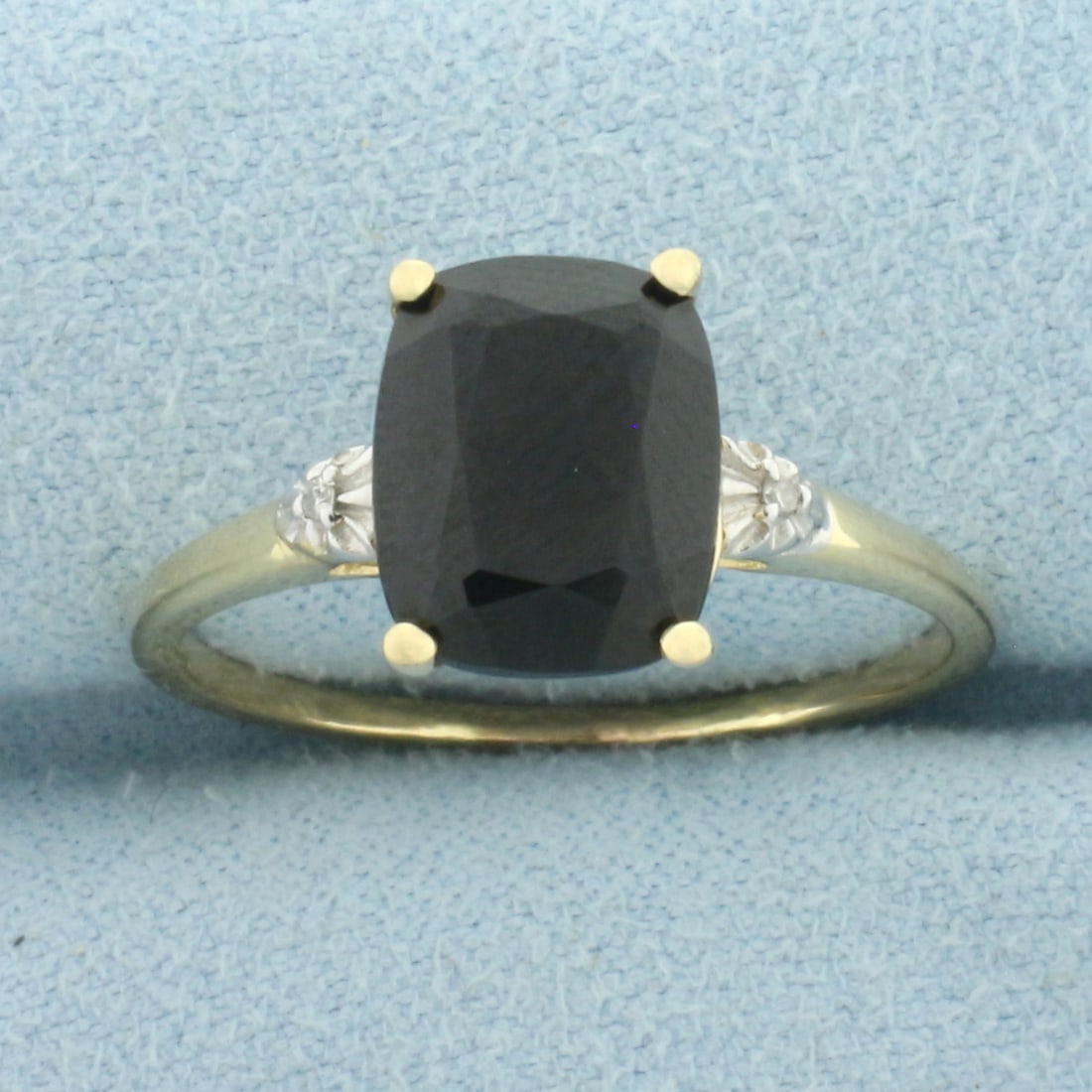 Sapphire and Diamond Ring in 14k Yellow Gold: In 14k Yellow Gold. Contains one natural high quality 10mmx8mm cushion cut sapphire, approximately 3ct, with deep color and excellent clarity. Also contains two 1/2pt high quality diamonds. Size 9.5. 