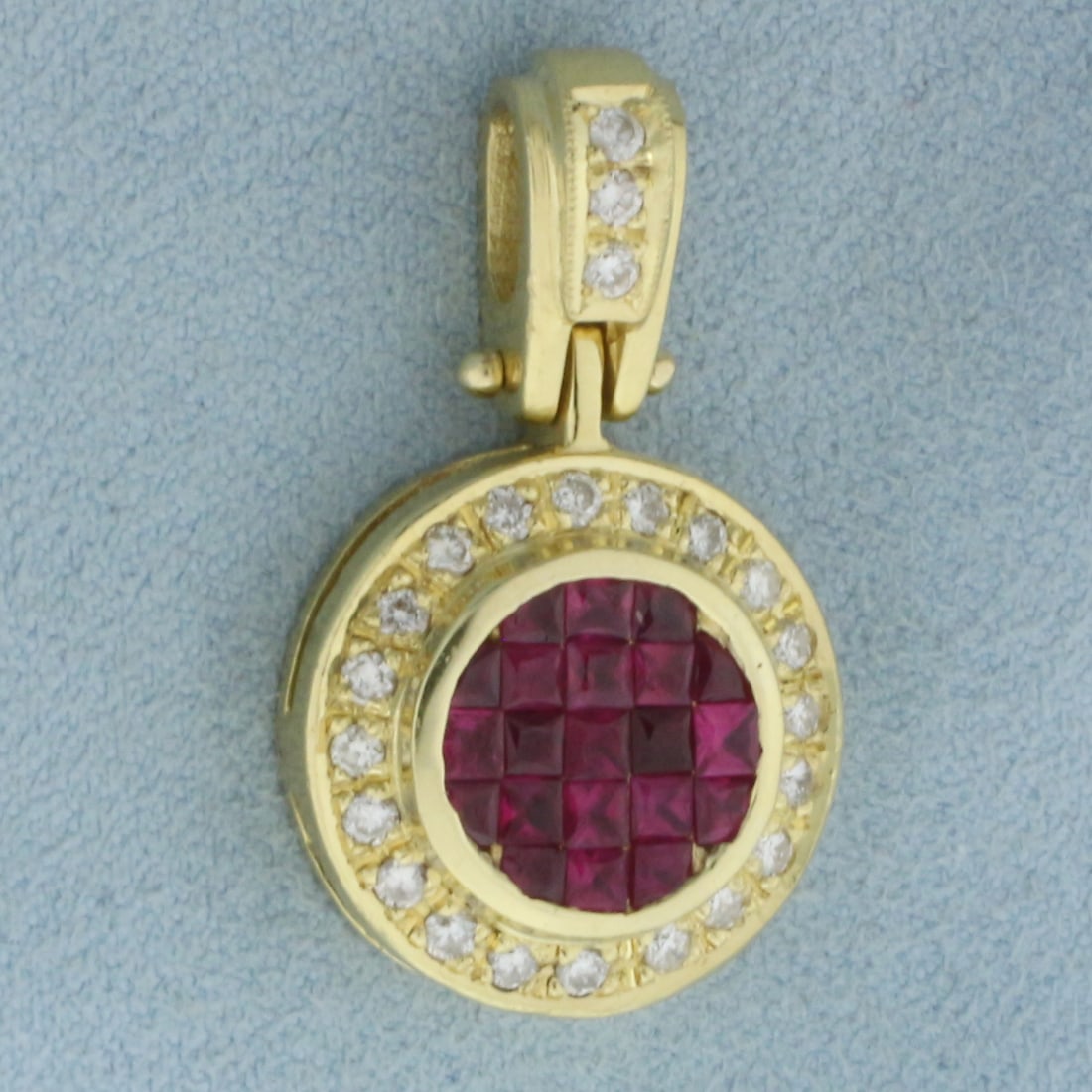 Ruby and Diamond Halo Pendant in 18k Yellow Gold: In 18k Yellow Gold. Contains twenty-one 2mm high quality princess cut natural Ruby gemstones, approximately 1ct TW, with intense color and excellent clarity. Also contains twenty-three high quality di