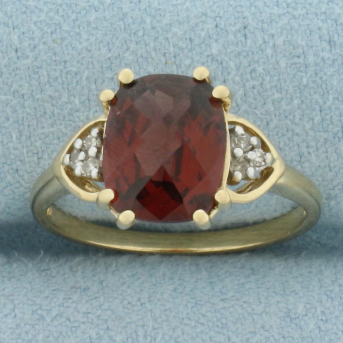 Checkerboard Garnet and Diamond Ring in 10k Yellow Gold: In 10k Yellow Gold. Contains one 10x8mm high quality checkerboard cushion cut natural Garnet gemstone, approximately 3cts, with intense color and excellent clarity. Also contains six high quality 1/2p