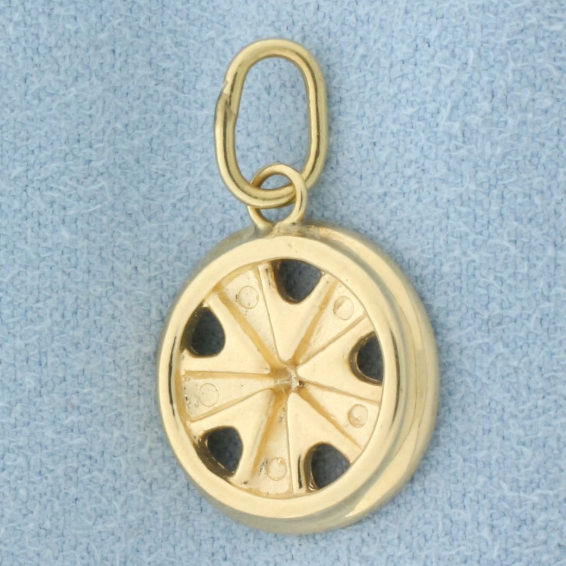 Tire Rim Charm in 14k Yellow Gold: In 14k Yellow Gold. 7/8 inch long 1/2 inch wide. 2.9g.