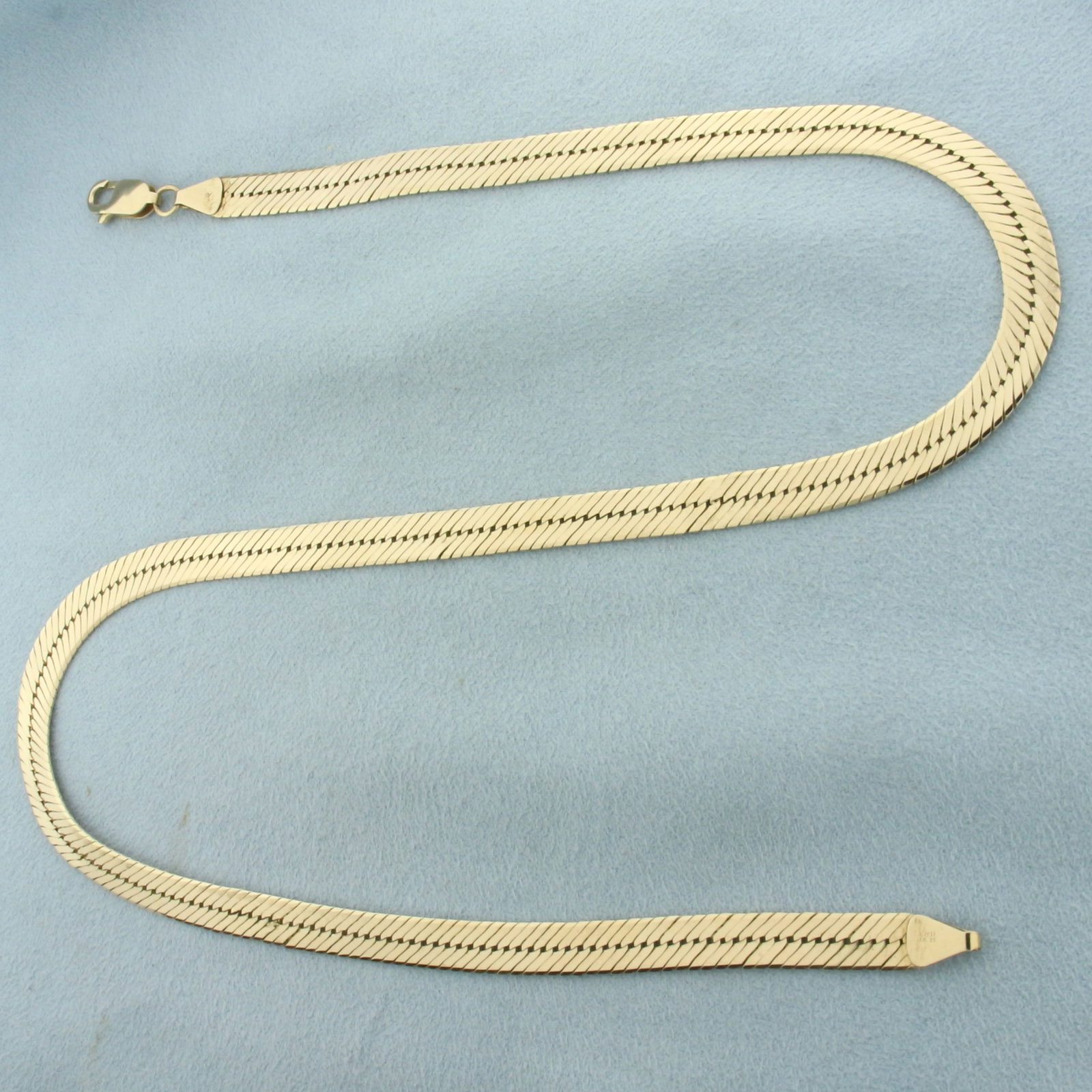 Italian 17 Inch Herringbone Link Chain Necklace in 14k Yellow Gold: In 14k yellow gold. Italian made. 17 inches long and 6mm wide. Lobster clasp. 18.8g.