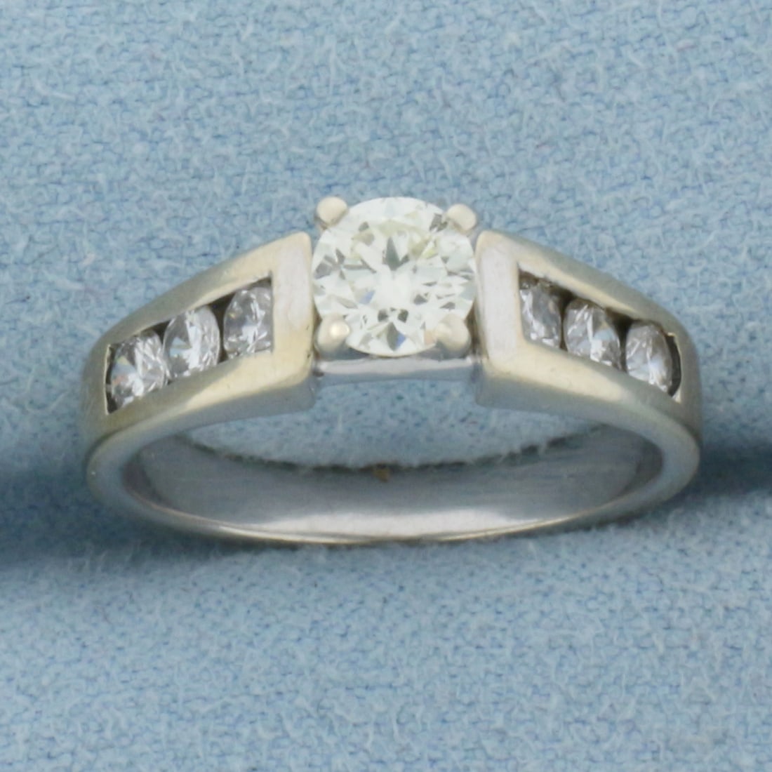Round Brilliant Diamond Engagement Ring in 14K White Gold: In 14K White Gold. Contains one high quality .45ct Diamond, VS clarity/I color. Also contains six high quality .05ct Diamonds, SI clarity/I color. Size 6 1/2. 4.3g.
