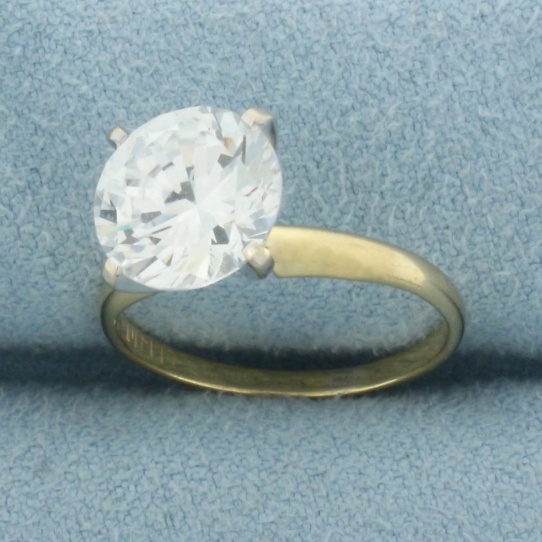 CZ Solitaire Engagement Ring in 14k Yellow Gold: In 14k Yellow Gold. Contains one 9mm high quality Cubic Zirconia gemstone, approximately 2.5ct, with excellent cut and clarity for added brilliance. Size 5. 2.8g.