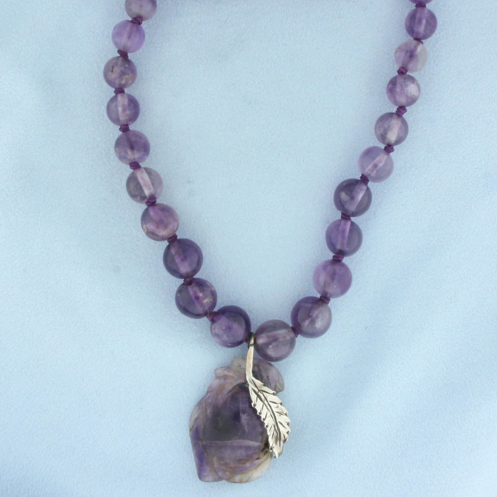 Amethyst Bead Feather Necklace in .925 Sterling Silver: .925 sterling silver feather. Contains 5.5mm to 11.5mm high quality Amethyst gemstone beads with bright color and excellent clarity. 29 inches long. Hand knotted. 74.7g.
