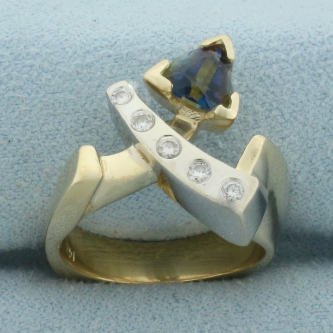 Topaz and Diamond Modern Design Ring in 14k Yellow and White Gold: In 14k Yellow and White Gold. Contains one high quality 6mm Topaz gemstone with intense blue and green color and excellent clarity. Also contains five high quality diamonds, 1/8ct TW, VS clarity/G col