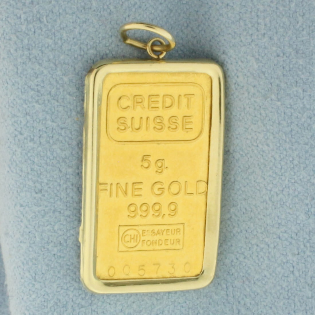 Credit Suisse Gold Bar Charm or Pendant in 14K Bezel: Bezel is 14k gold. Contains 1 Credit Suisse 5g gold bar (.9999 pure gold). Measures 1.125 inches long (including jump ring) by 0.5 inches wide. 5.5g