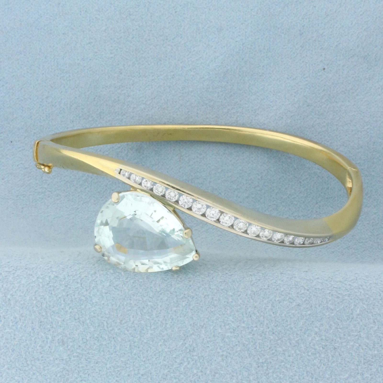 Aquamarine and Diamond Hinged Bangle Bracelet in 18k Yellow Gold: In 18k yellow gold. Contains one high quality natural 9ct pear cut Aquamarine gemstone with bright aqua blue green color and excellent clarity. Also contains 18 high quality diamonds, 3/4ct TW, VS cla