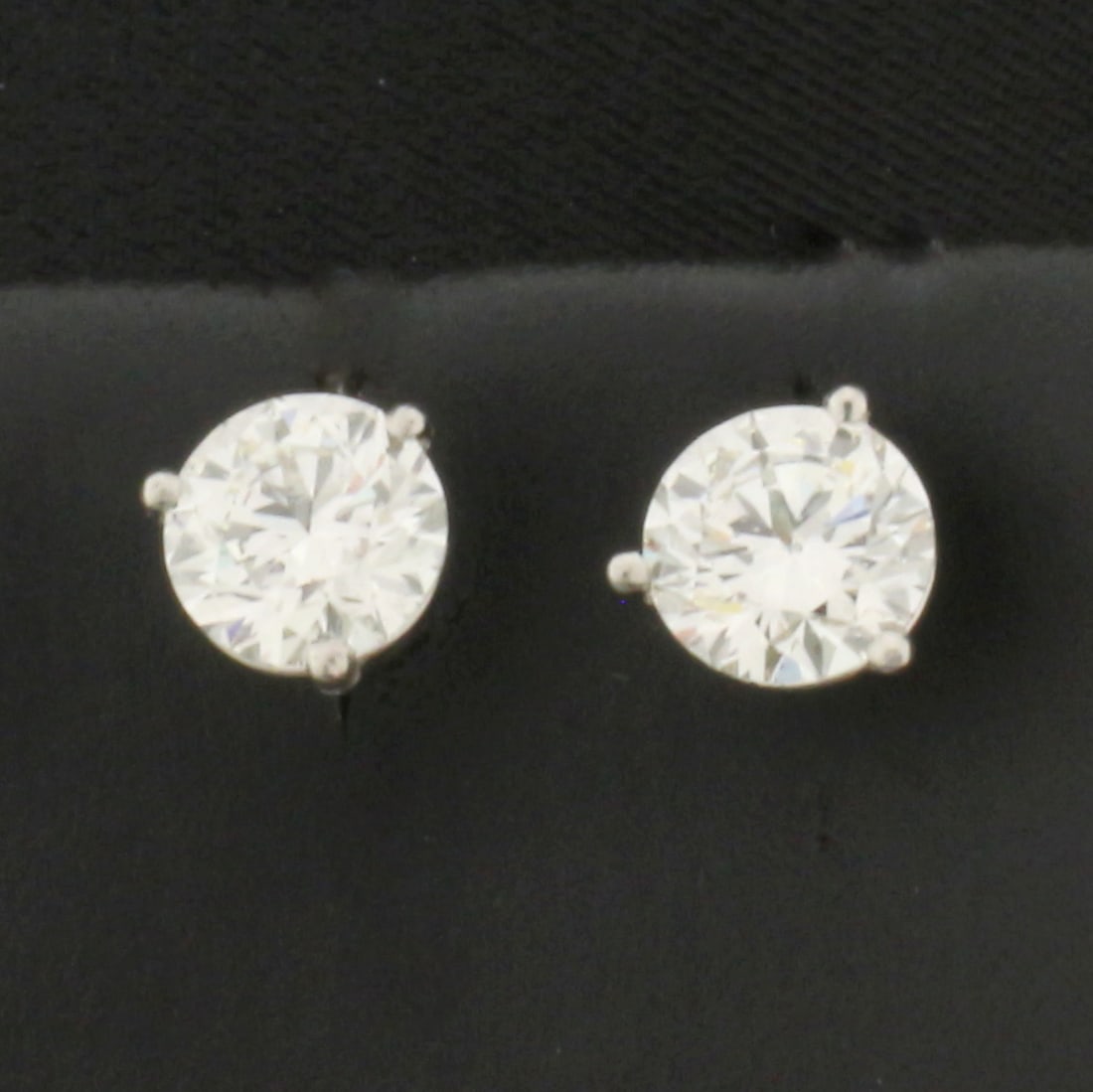 GIA Certified Over 2ct TW Diamond Stud Earrings in Platinum Martini Settings: In platinum martini settings. Contains one 1.01ct and one 1.00ct high quality round brilliant diamonds, J color/SI2 clarity, triple excellent cut for amazing brilliance, eye clean. Each GIA certified.