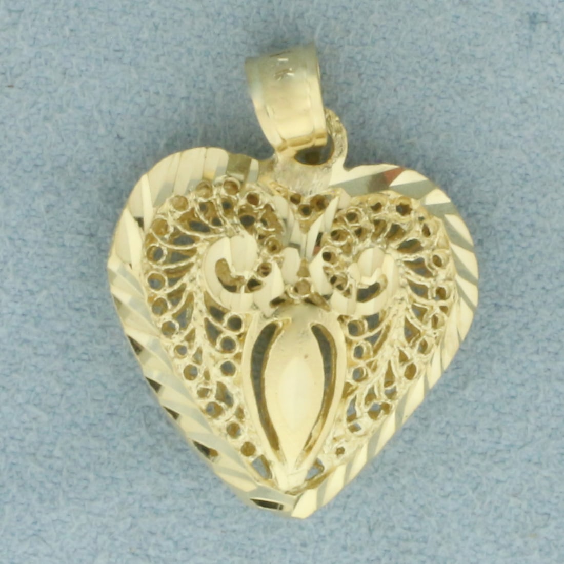 Lace Heart 3D Pendant in 14k Yellow Gold: In 14k Yellow Gold. 1 inch long including bale. 3/4 inch wide. 3D. Diamond cut details. 3.3g.