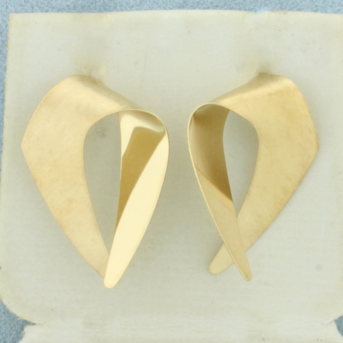 Satin and High Polish Abstract Design Earrings in 14k Yellow Gold: In 14k Yellow Gold. 1 inch long. 5/8 inch wide. Half satin finish, half high polish finish for unique look. Friction backs. 1.8g.