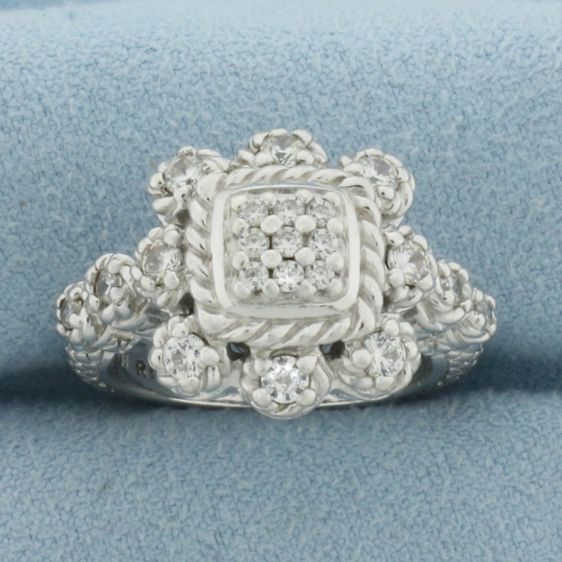 Judith Ripka Diamonique Ring in Sterling Silver: In .925 Sterling Silver. Accented with high quality Cubic Zirconia gemstones. 15.6mm wide. Designer Judith Ripka marking. Size 7.