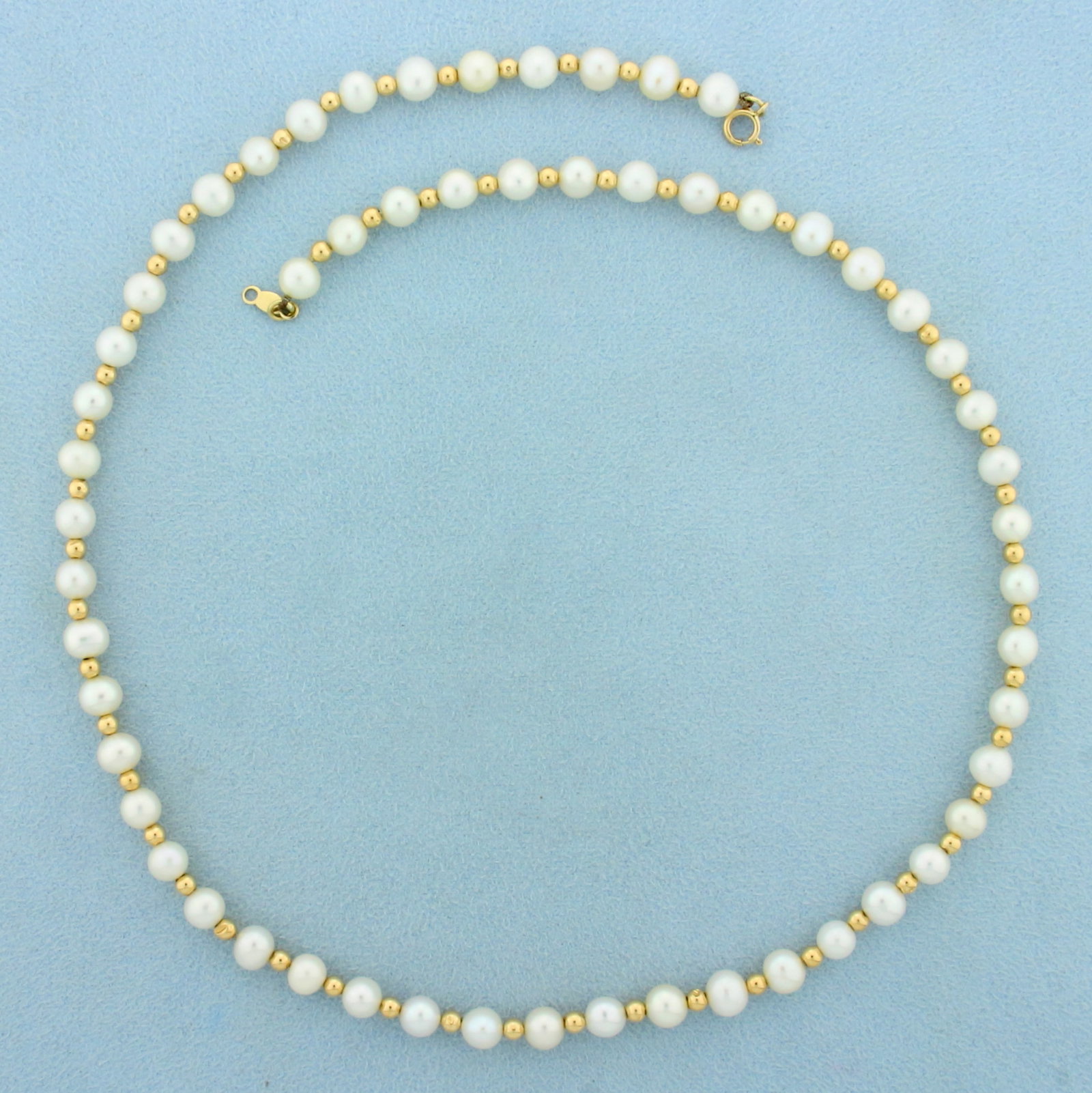 Gold Ball Bead and Pearl Necklace in 14K Yellow Gold: In 14K Yellow Gold. Contains fifty seven high quality 5mm Cultured Pearls with high luster. Also contains fifty six 3mm gold beads. 18 inches long. 13.2g