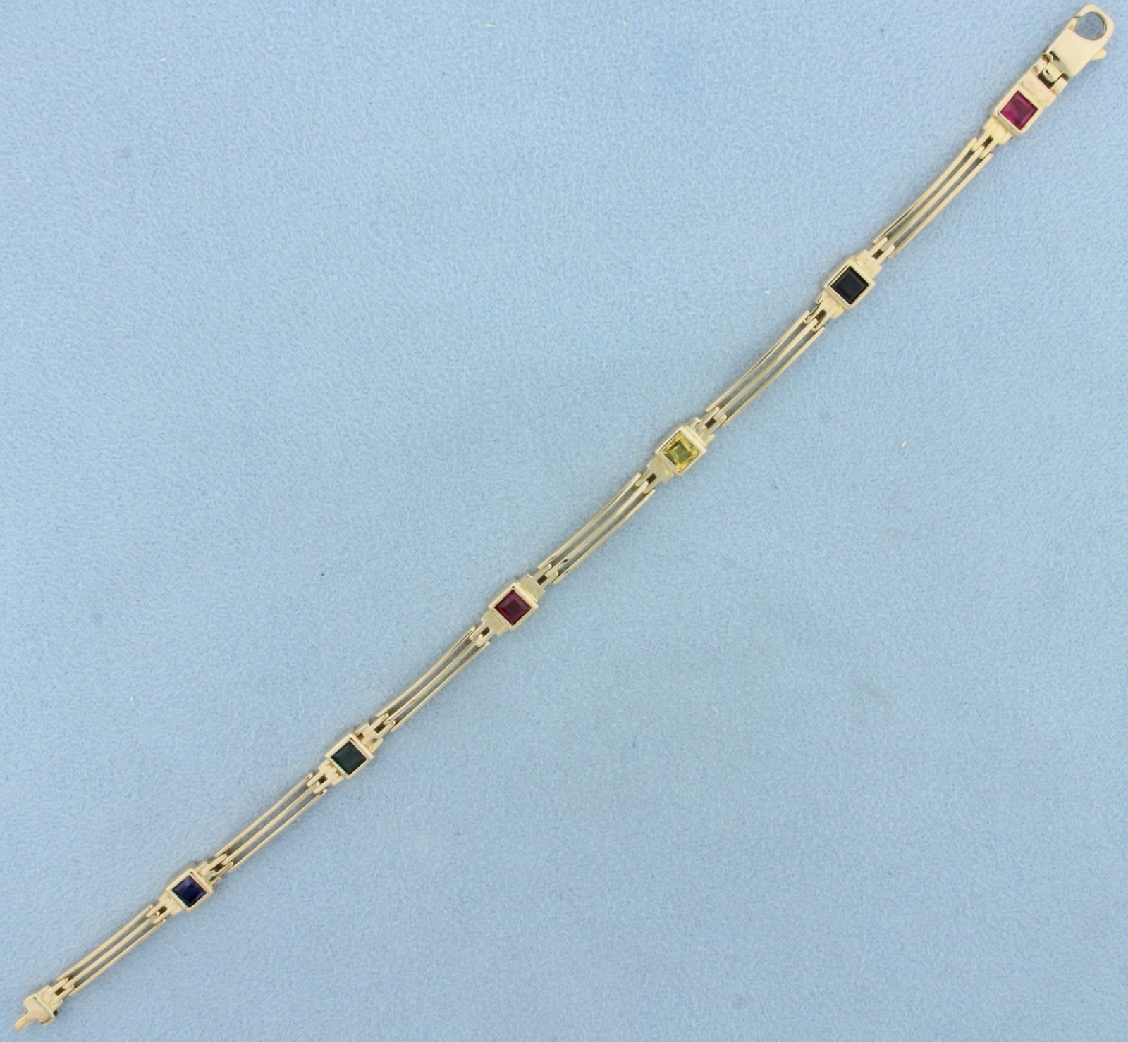 Rainbow Sapphire Bracelet in 14k Yellow Gold: In 14k yellow gold. Contains six 1/3ct High Quality Natural Sapphire gemstones in various colors, 2ct TW, with vibrant color and excellent clarity. 7 1/2 inches long, Lobster clasp. 11.2g.