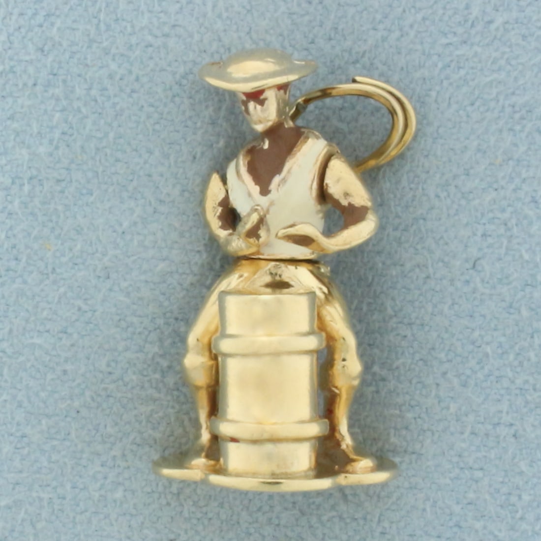 Vintage Mechanical Steel Drummer Charm in 14k Yellow Gold: In 14k yellow gold with enamel detail. Charm rotates at waist to mimic drumming. 1 inch high, 1/2 inch wide. 5.3g.