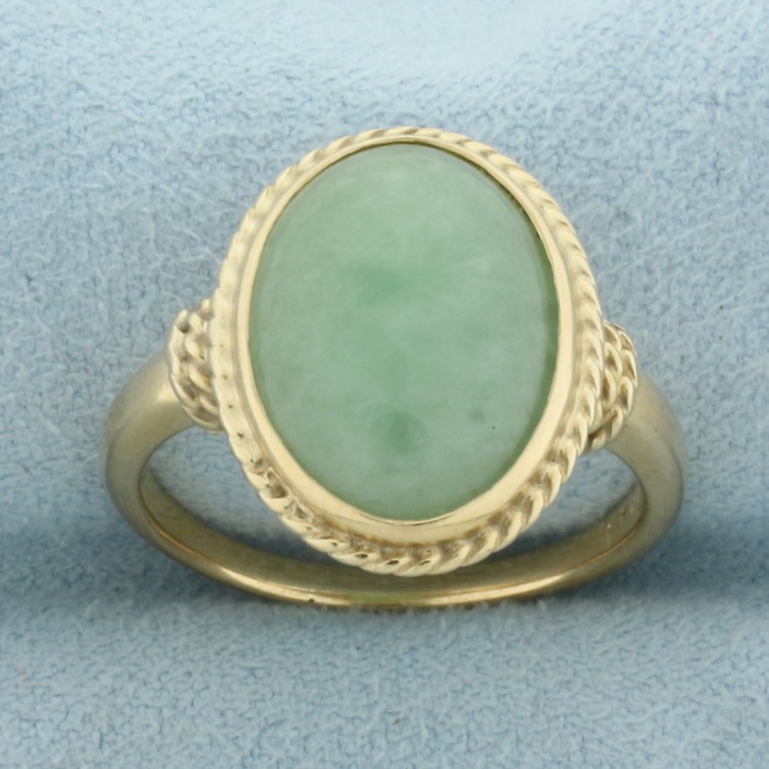 Jade Solitaire Ring in 14k Yellow Gold: In 14k Yellow Gold. Contains one 16mm by 11mm high quality natural Jade gemstone. Size 9. 5.8g.