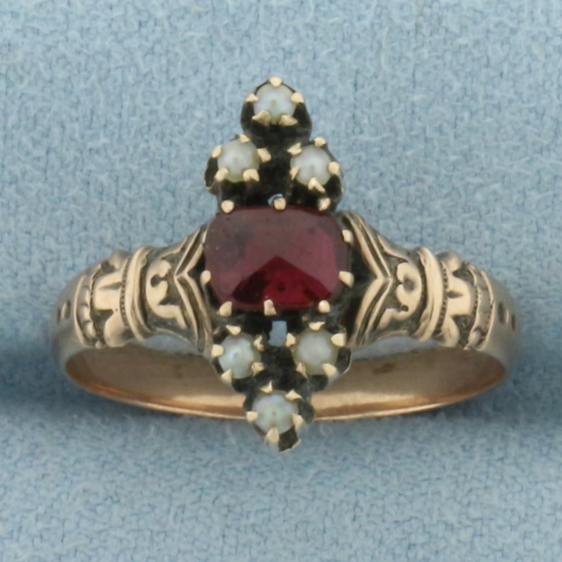 Antique Victorian Garnet and Seed Pearl Ring in 10k Rose Gold: In 10k Rose Gold. Contains one 6mm high quality fancy cut natural Garnet gemstone with deep color. Also contains six 1.7mm high quality seed pearls. Size 7.5. 2.8g.
