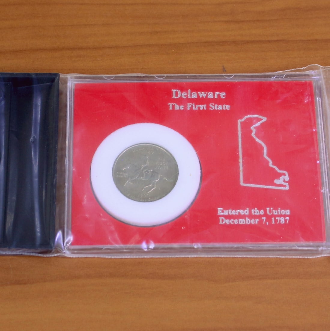 1999 Delaware State Quarter In Case With Stand: Contains one 1999 Delaware State Quarter. Set in plastic casing and contains display holder.