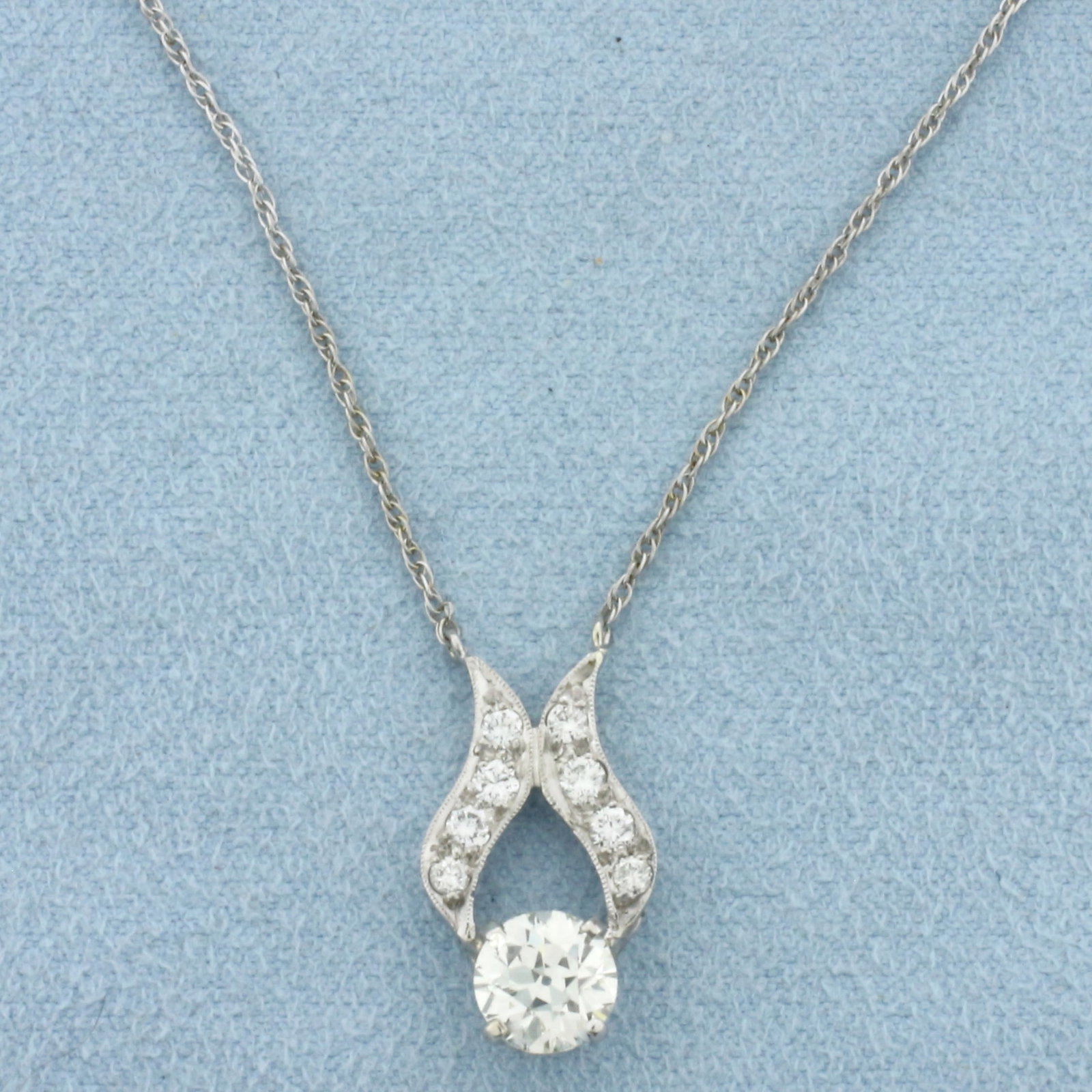 Antique Old European Cut Diamond Necklace in 14k White Gold: In 14k White Gold. Contains one 1.02ct European cut diamond, VS clarity/I color. Also contains eight .03ct diamonds of similar high quality. Chain is 15 1/2 inch long. 1mm wide. Pendant is 3/4 inch lo