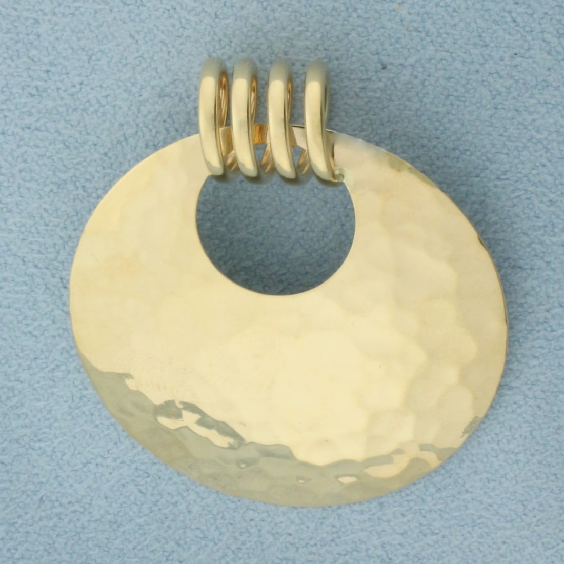 Hammered Finish Disk Coil Pendant in 14k Yellow Gold: In 14k Yellow Gold. 1 3/8 inch long. 1 1/4 inch wide. 2.3g.