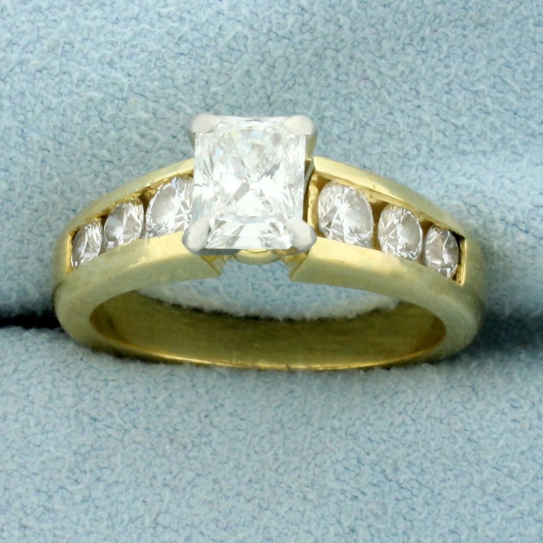 EGL Certified Radiant Diamond Engagement Ring in 18K Yellow Gold: In 18K Yellow Gold. Contains EGL certified .9ct Radiant diamond, VS1 clarity/E color. Also contains six high quality round brilliant diamonds, .6ct TW, of similar high quality. Size 6 1/2. 7.6g