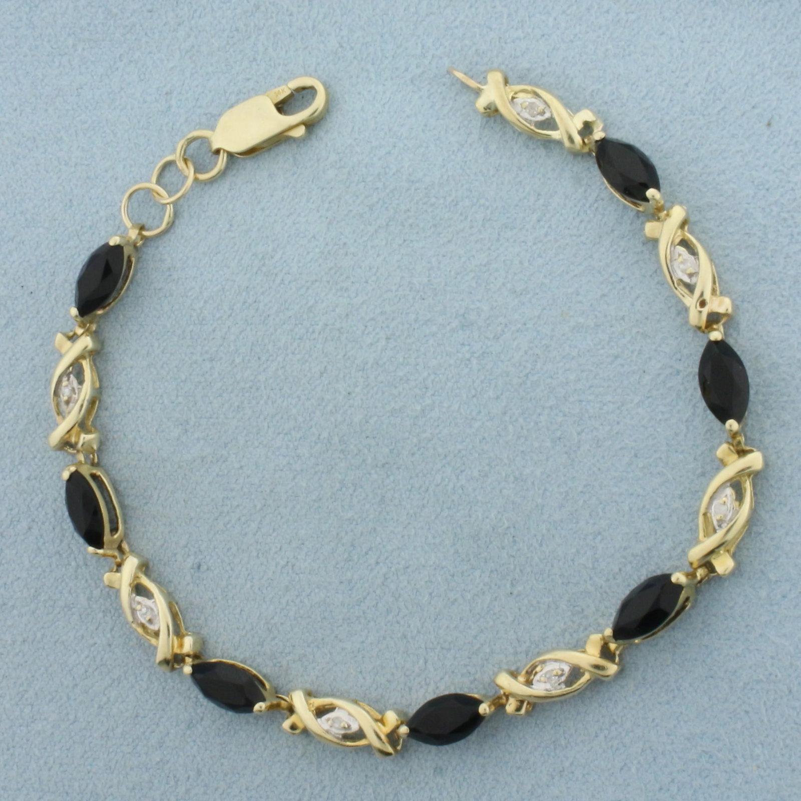 Black Tourmaline and Diamond Bracelet in 14k Yellow Gold: In 14k Yellow Gold. Contains seven 4x8mm high quality marquise natural Tourmaline gemstones, approximately 5ct TW. Also contains seven high quality 1/2pt diamonds. 6.75 inches long. 1/8 inch wide. Lob