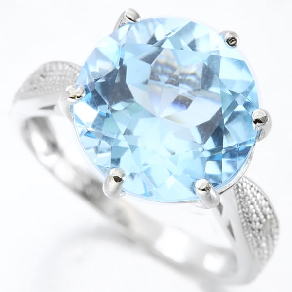 Huge Blue Topaz and Diamond Statement Ring in Sterling Silver: In platinum over .925 sterling silver. Contains one 7.3ct blue topaz gemstone, accented with two genuine diamonds, .01ctw. Size 7. 4.3g