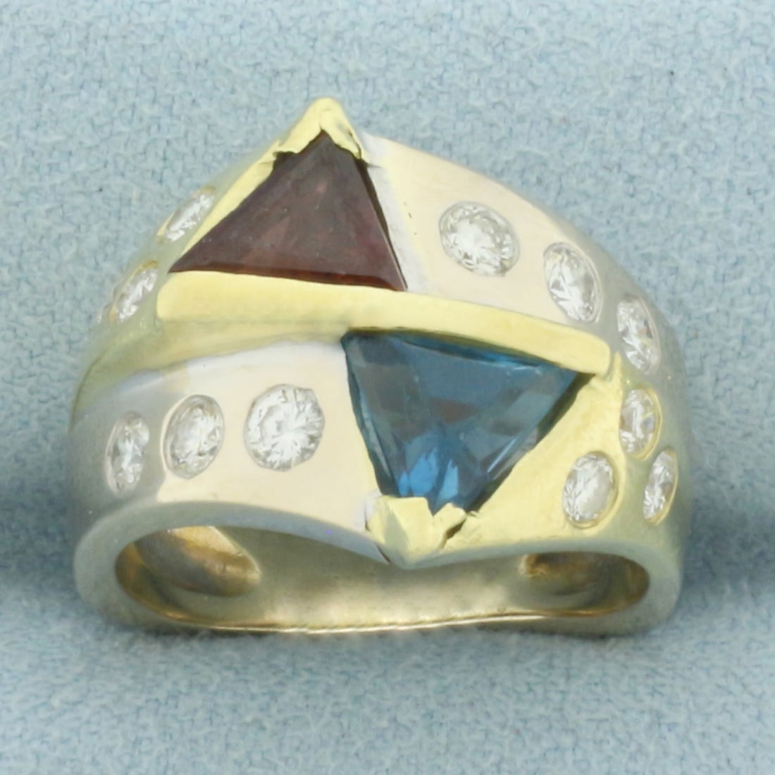 Tourmaline, Rubellite, and Diamond Ring in 18k Yellow and White Gold: In 18k Yellow and White Gold. Contains one 7.5mm Blue Tourmaline and one 7.5mm Rubellite trillion cut high quality natural gemstones with vibrant color. Also contains ten high quality diamonds, 3/4ct 