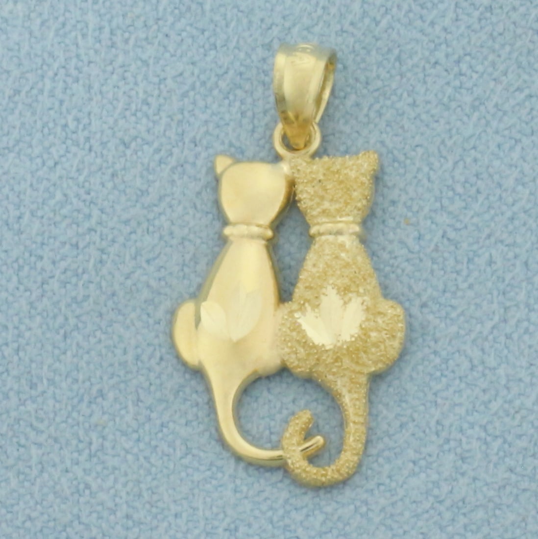 Two Cats Pendant or Charm in 14k Yellow Gold: In 14k Yellow Gold. 1 inch long (including bale). 1/2 inch wide (at widest). One cat is high shine finish, one sandblast finish for unique look. 0.9g.