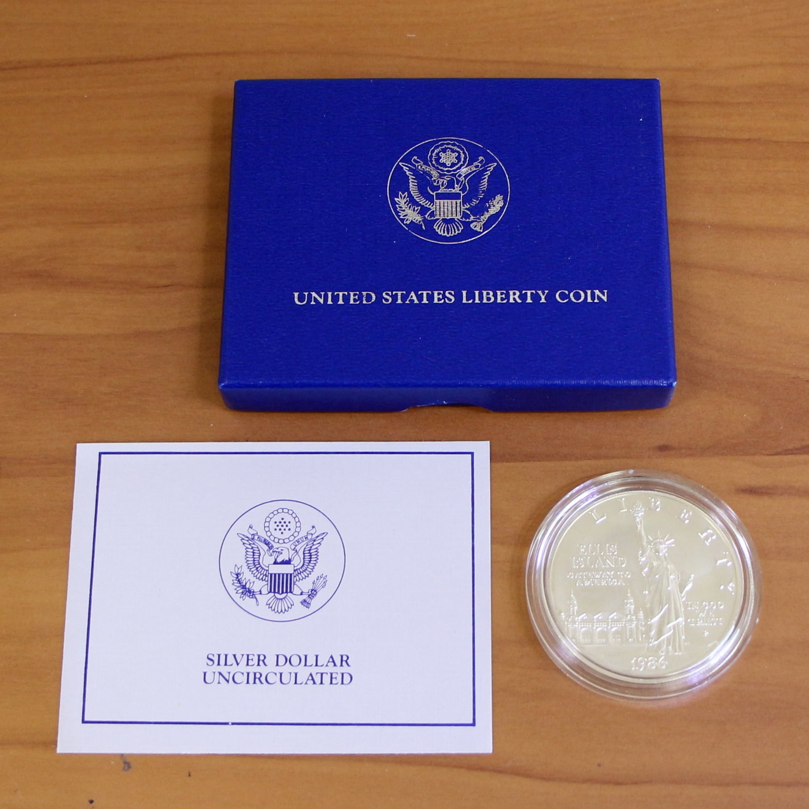 1986 US Liberty Uncirculated Silver Dollar OGP: Contains one 1986 United States Liberty Uncirculated Silver Dollar. Includes original government packaging and contains certificate of authenticity.