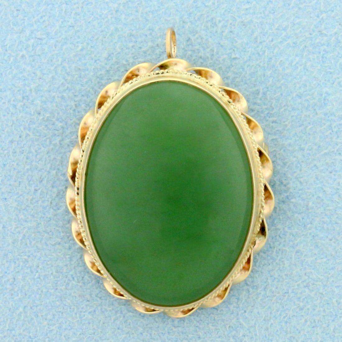 Large Vintage Jade Pendant or Pin in 14K Yellow Gold: In 14K Yellow Gold. Contains one high quality natural 18ct cabochon cut Jade gemstone with vibrant green color and excellent clarity. 1 1/4 inches long. 1 inch wide. Bale can fold into piece when worn