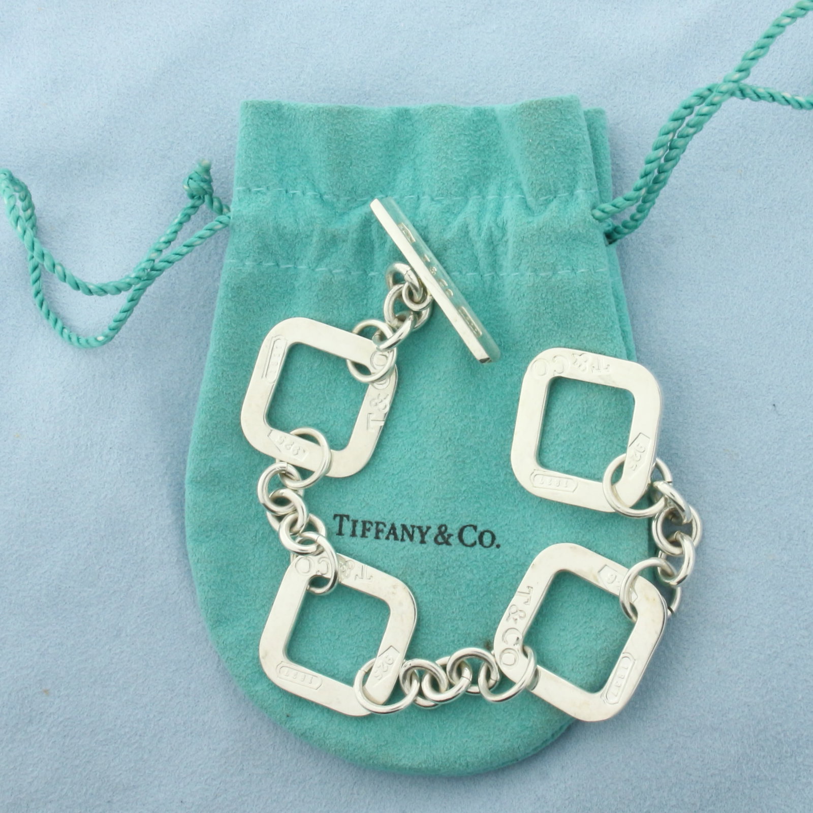 Tiffany and Co. Square Link 1837 Toggle Bracelet in Sterling Silver: In .925 Sterling Silver. 8 inches long. 1 1/8 inch wide links. Pouch included. Toggle closure. 29.8g.