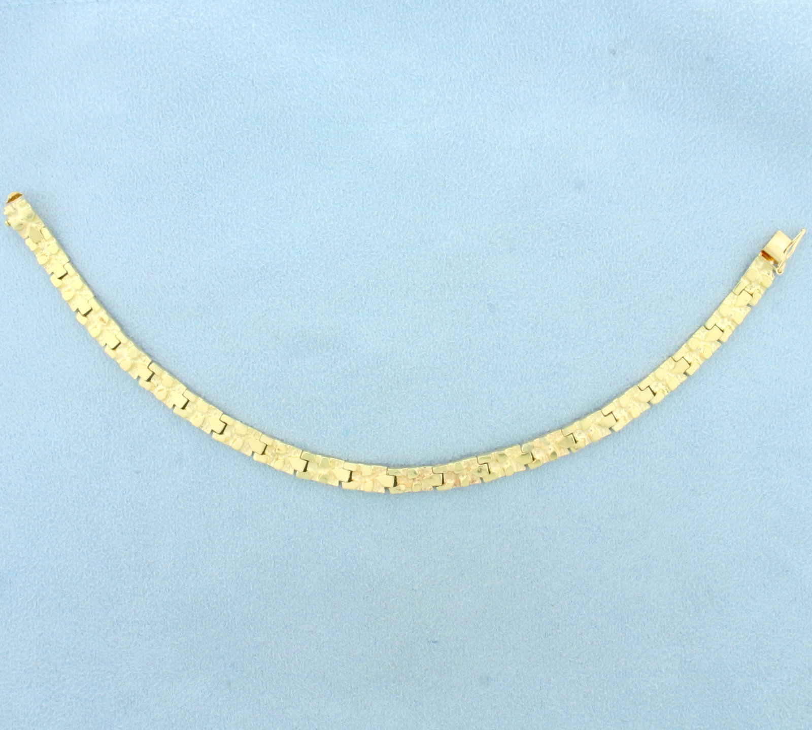 Nugget Design Link Bracelet in 14K Yellow Gold: In 14K Yellow Gold. 7 1/8 inches long. 5.5mm wide. Safety clasp. 9.3g