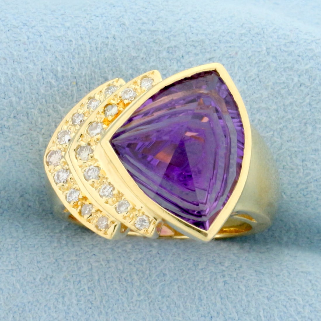 Designer Fancy Amethyst And Diamond Ring in 14k Yellow Gold: In 14k yellow gold. Contains a high quality natural 15mm Amethyst gemstone with intense purple color and excellent clarity. Also contains eighteen high quality .01ct diamonds, SI clarity/H color. Size