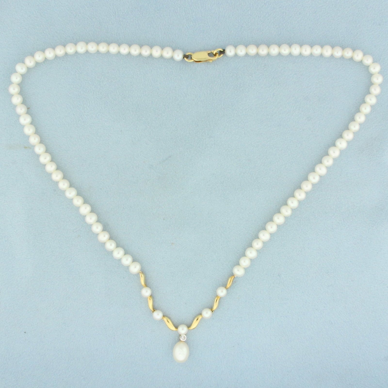 Mikura Pearl and Diamond Necklace in 18k Yellow Gold: In 18k yellow gold. Center pearl is high quality 9mm freshwater pearl with high luster and beautiful color. Pearls in necklace are 5mm also with high luster and beautiful color. Also includes one .01c