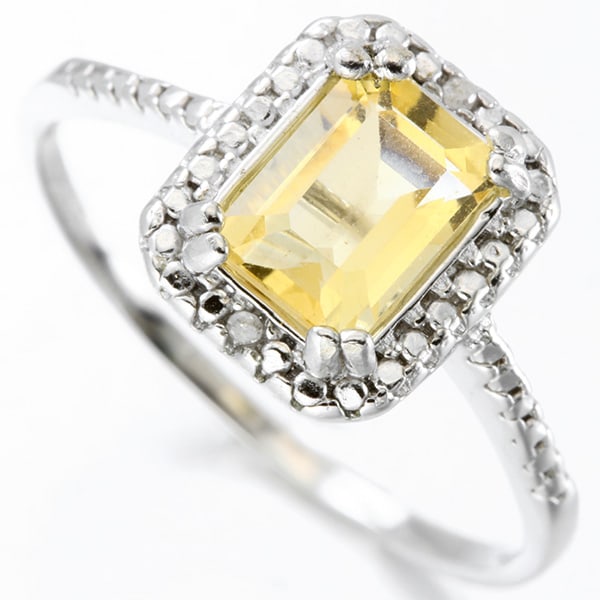 Citrine and Diamond Halo Ring in Sterling Silver: In platinum over .925 sterling silver. Contains one emerald cut citrine gemstone, .9cts, accented with two genuine diamonds, .01ctw. Size 7. 1.8g