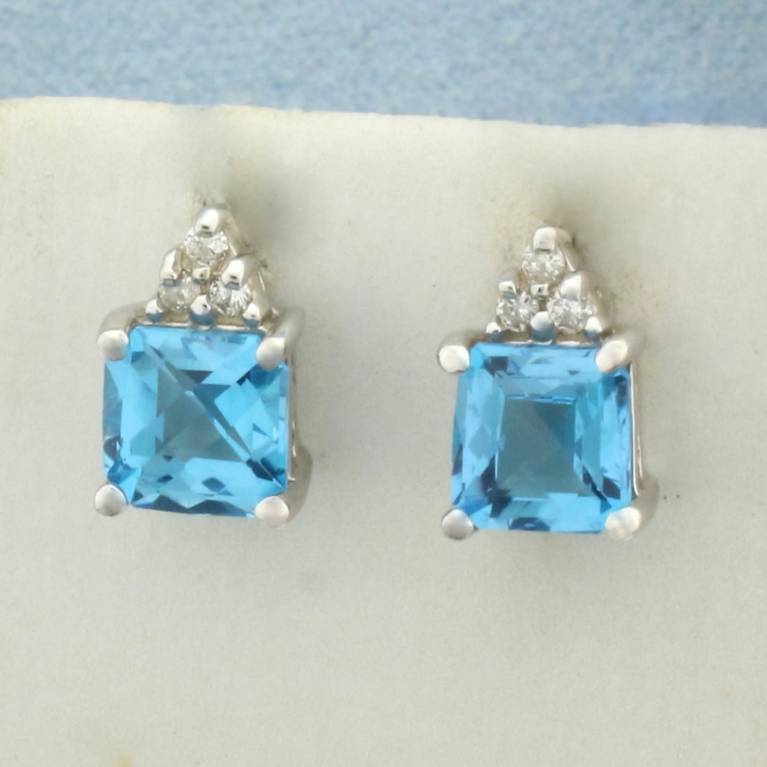Swiss Blue Topaz and Diamond Earrings in 14k White Gold: In 14k White Gold. Contains two high quality natural 6mm Swiss Blue topaz gemstones with electric blue color and excellent clarity. Also contains six .01ct high quality diamonds, SI clarity/H color. F