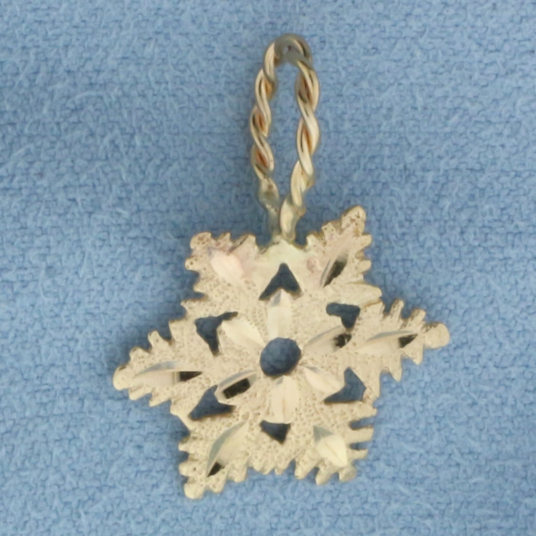 Diamond Cut Snowflake Pendant in 14k Yellow Gold: In 14k yellow gold. Measures 7/8 inch long (including bail) x 5/8 inch wide. 1.0g.