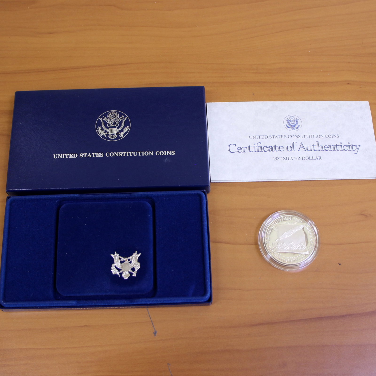 1987 US Mint Constitution Silver Dollar Coin OGP: Contains one 1987 United States Constitution Commemorative Silver Dollar. Set in original government packaging and contains certificate of authenticity.