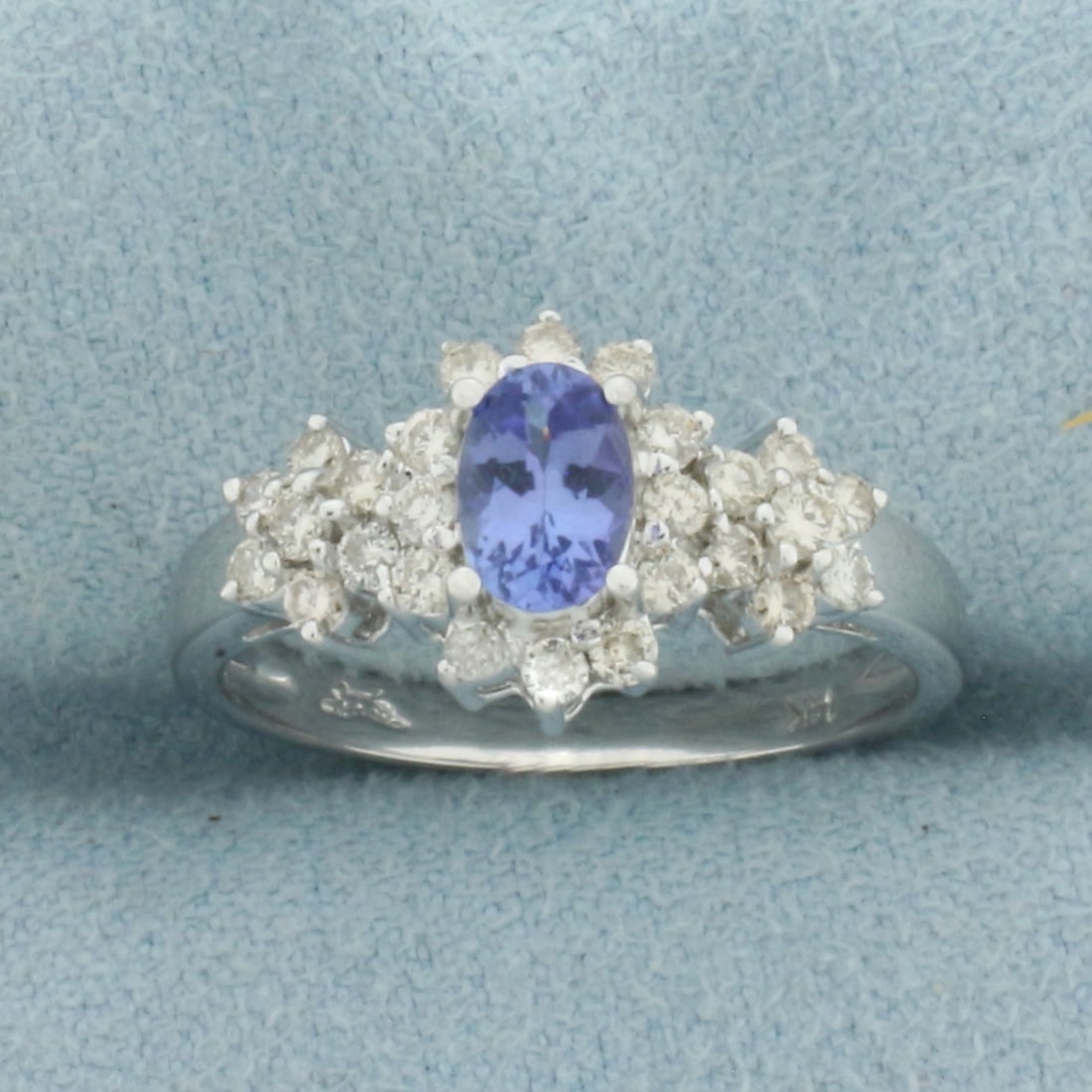 AAA Tanzanite and Diamond Flower Ring in 14k White Gold: In 14k White Gold. Contains one 6x4mm AAA quality natural Tanzanite gemstone, approximately 1/2ct, with vibrant color and excellent clarity. Also contains twenty-five high quality diamonds, 1/3ct TW, 
