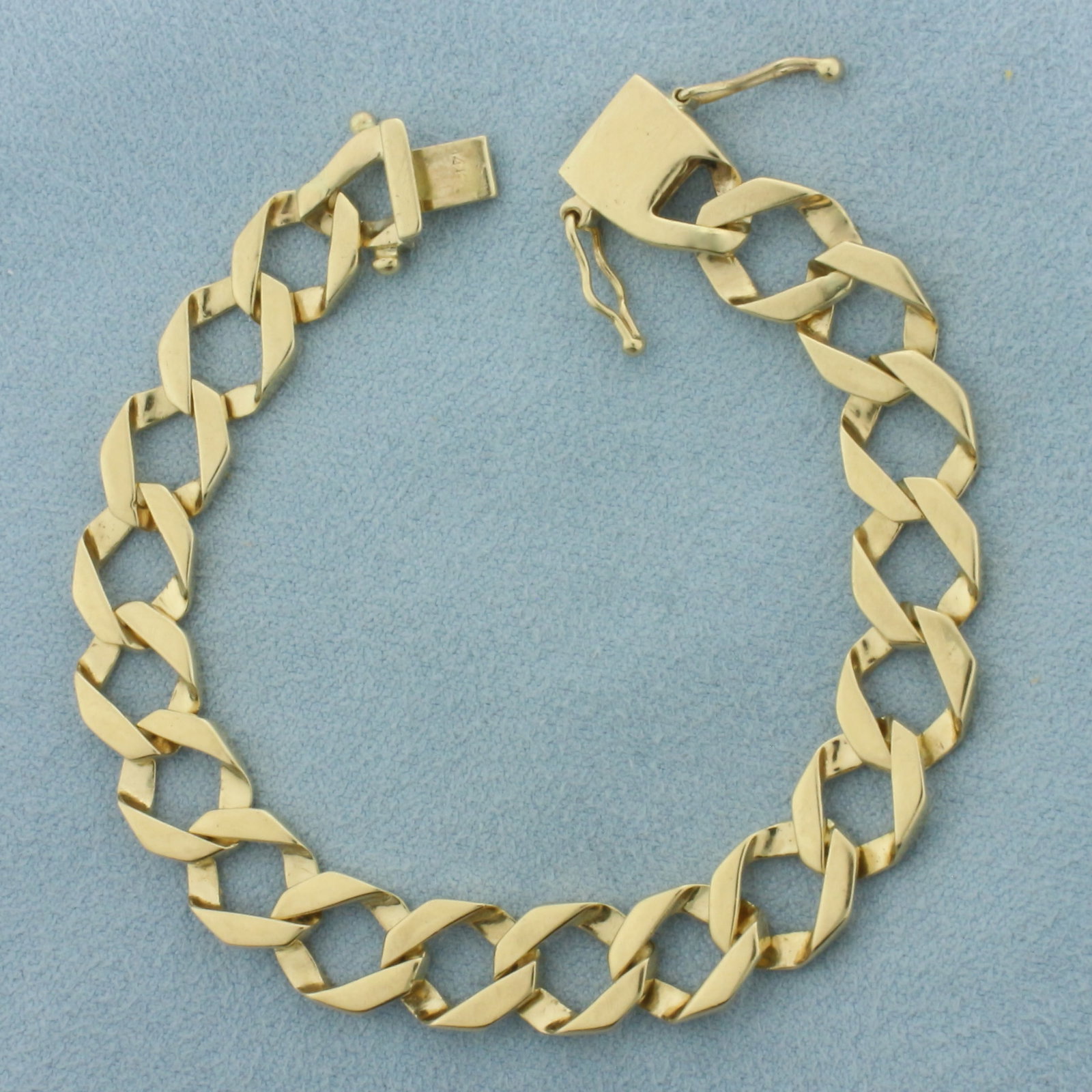 Curb Link Bracelet in 14K Yellow Gold: In 14k yellow gold. Measures 6 7/8 inches long by 0.375 inches wide. Slide clasp with double safety latches. 17.9g