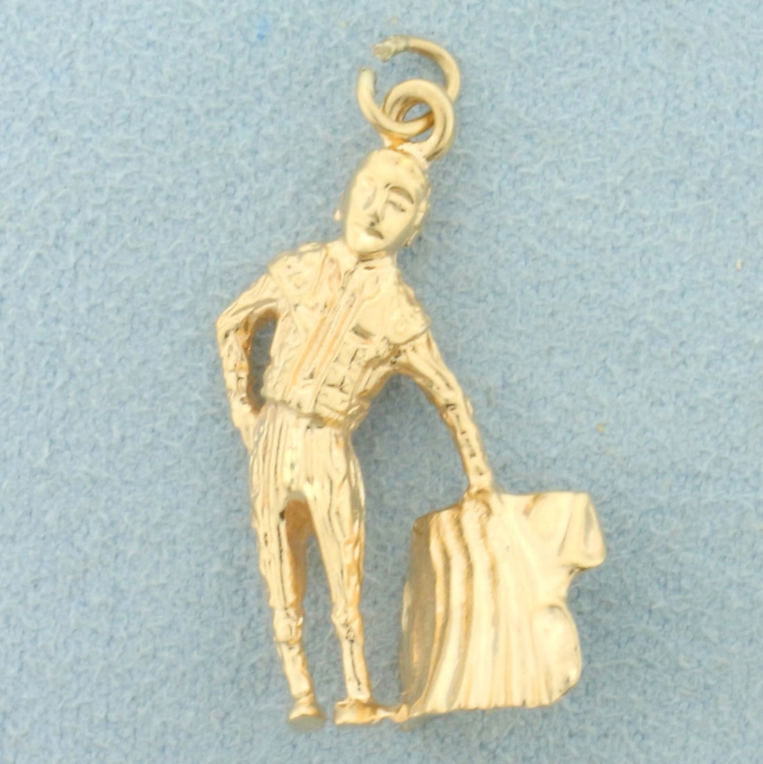 Bull Fighting Matador Charm or Pendant in 14K Yellow Gold: In 14K Yellow Gold. 1 1/4 inch long with jump ring, 1/2 inch wide. 5.0g.
