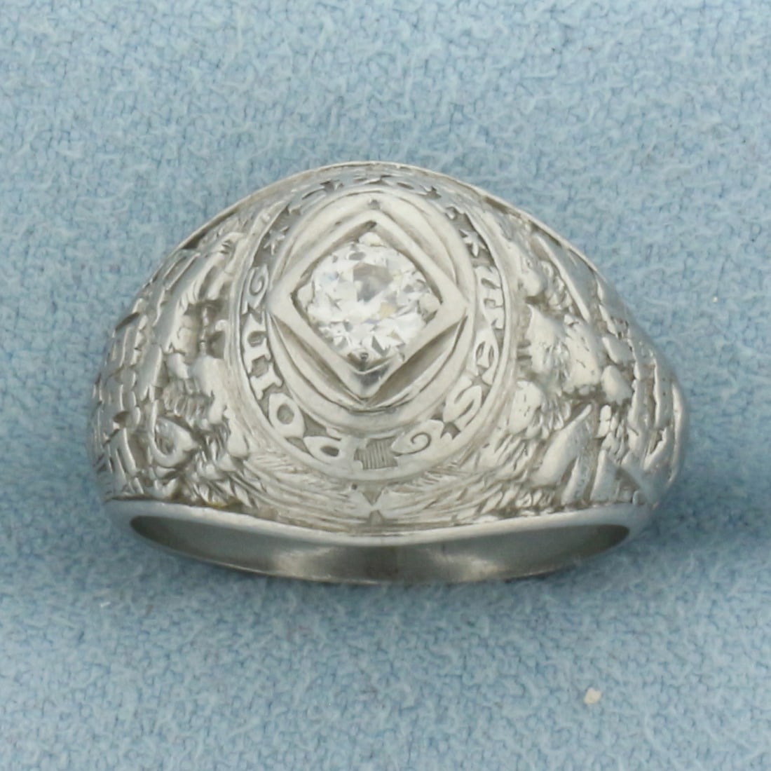 1945 West Point Diamond Class Ring in Palladium: In Palladium. Contains one 1/4ct high quality Old European cut diamond, SI clarity/H color. 13.3mm wide at center. Size 6. 7.7g.