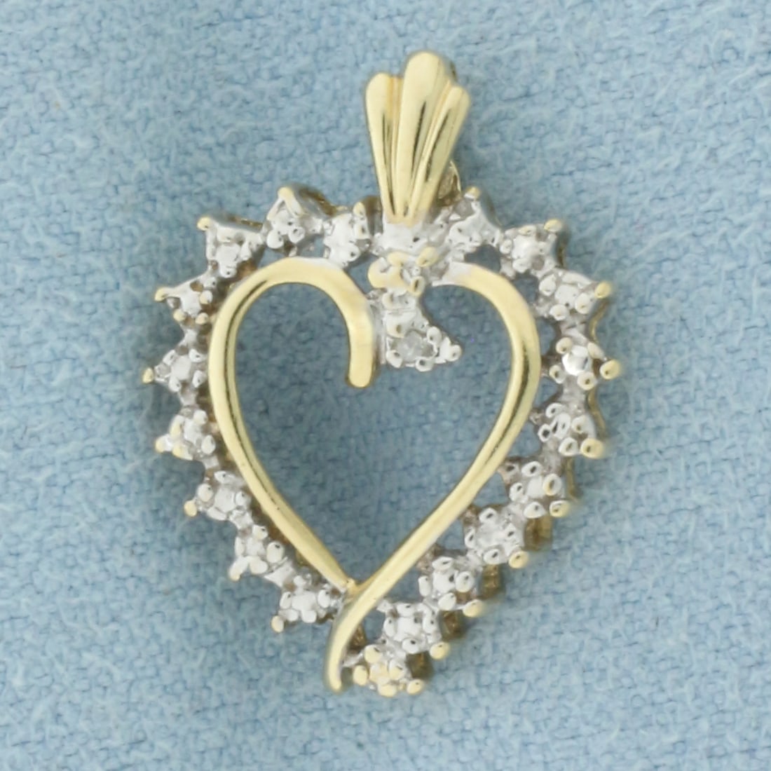 Diamond Heart Pendant in 10k Yellow Gold: In 10k Yellow Gold. Contains one .01ct high quality diamond.. 3/4 inch long. 1/2 inch wide. 1.3g