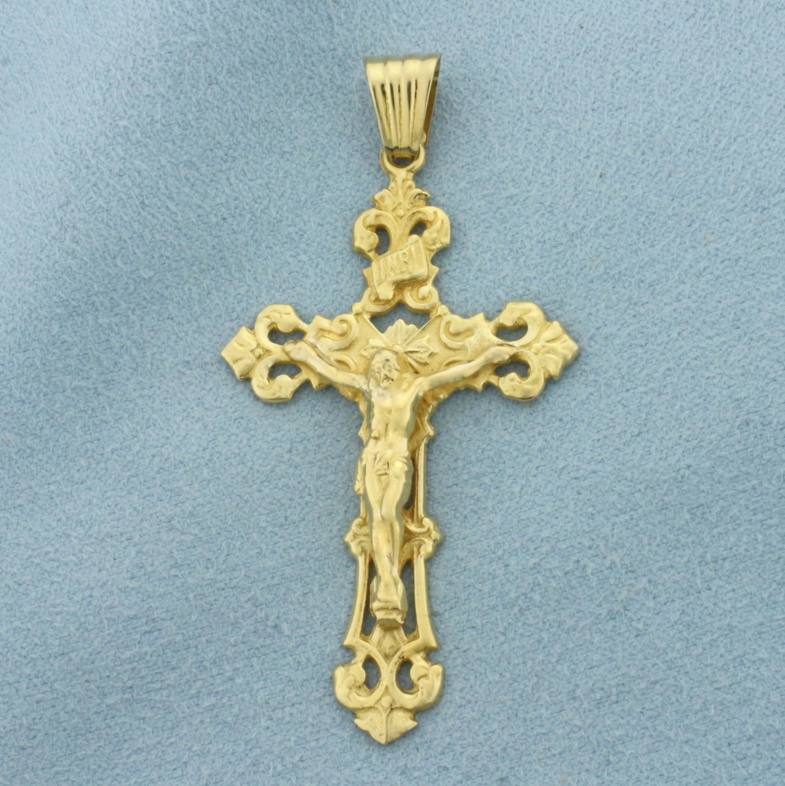 Crucifix Cross Pendant in 18k Yellow Gold: In 18k Yellow Gold. 2 1/8 inches long (including bale). 1 1/8 inch wide. 5.6g.