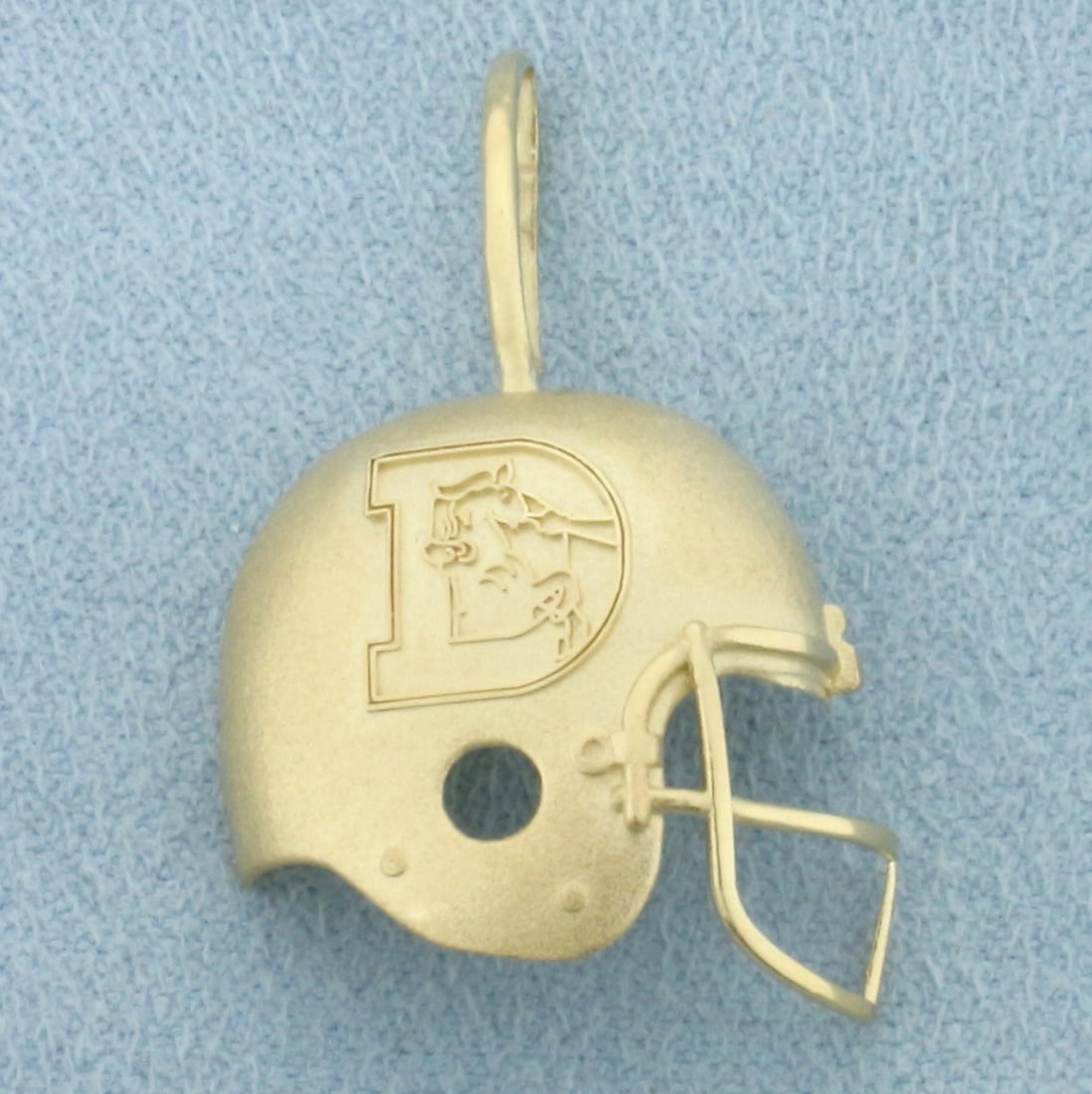 Denver Broncos Football Helmet Pendant in 14k Yellow Gold: In 14k Yellow Gold. 1 1/4 inch long (including bale). 3/4 inch wide at widest. 1.7g.