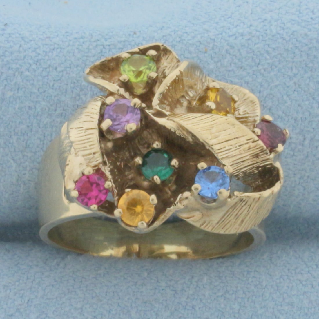 Rainbow Topaz Abstract Design Modern Ring in 10K Yellow Gold: In 10k yellow gold. Measures 18.5mm wide at top of ring. Contains eight high quality natural 3mm Topaz gemstones in various colors, all with bright color and excellent clarity. Size 8.75. 9.1g.