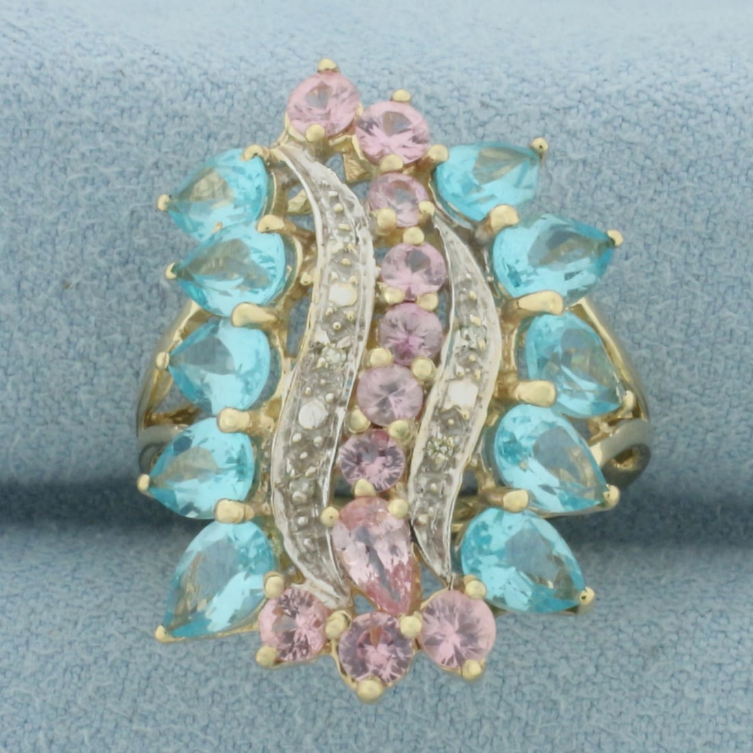 Blue and Pink Topaz and Diamond Ring in 10k Yellow Gold: In 10k Yellow Gold. Contains ten 6x4mm high quality pear Blue Topaz gemstones, approximately 5ct TW, with bright color and excellent clarity. Also contains one 5mm pear and ten 3mm round natural Pink 